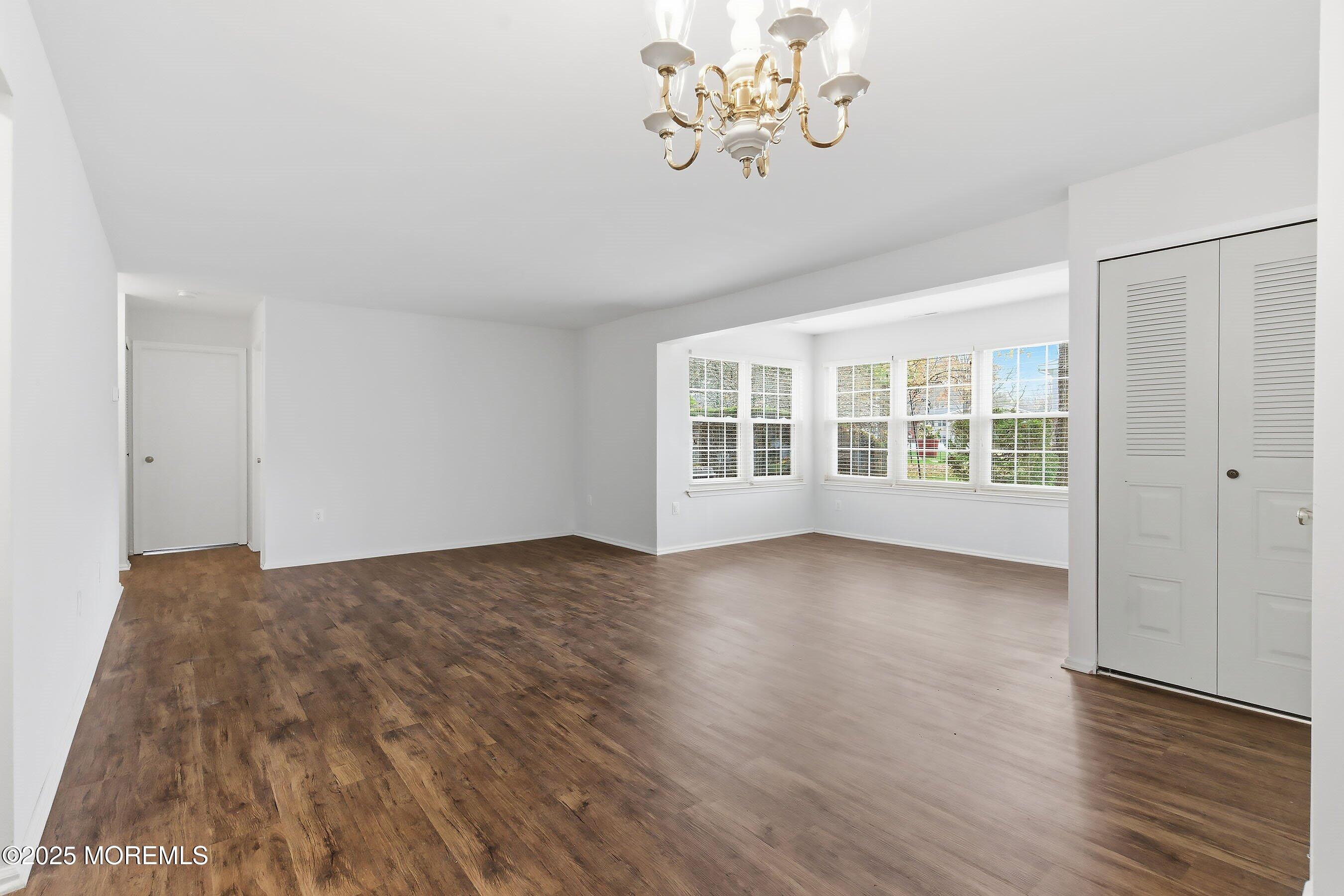 7 Boxwood Terrace, Unit 250 Red Bank, NJ 07701 - Photo 5 of 29 a view of an empty room with wooden floor and a window