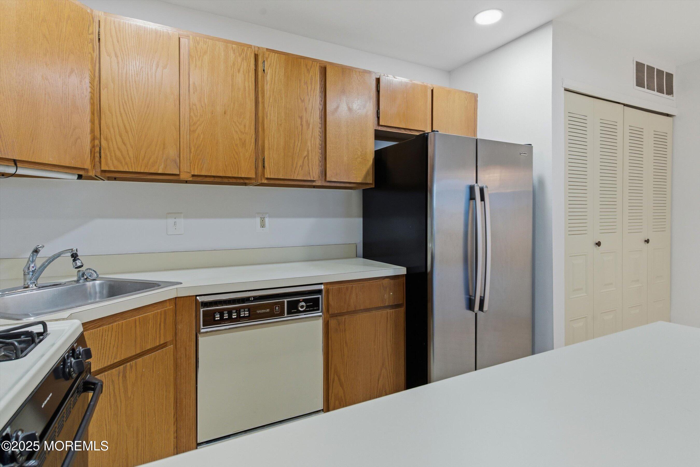 7 Boxwood Terrace, Unit 250 Red Bank, NJ 07701 - Photo 9 of 29 a kitchen with a refrigerator sink and cabinets