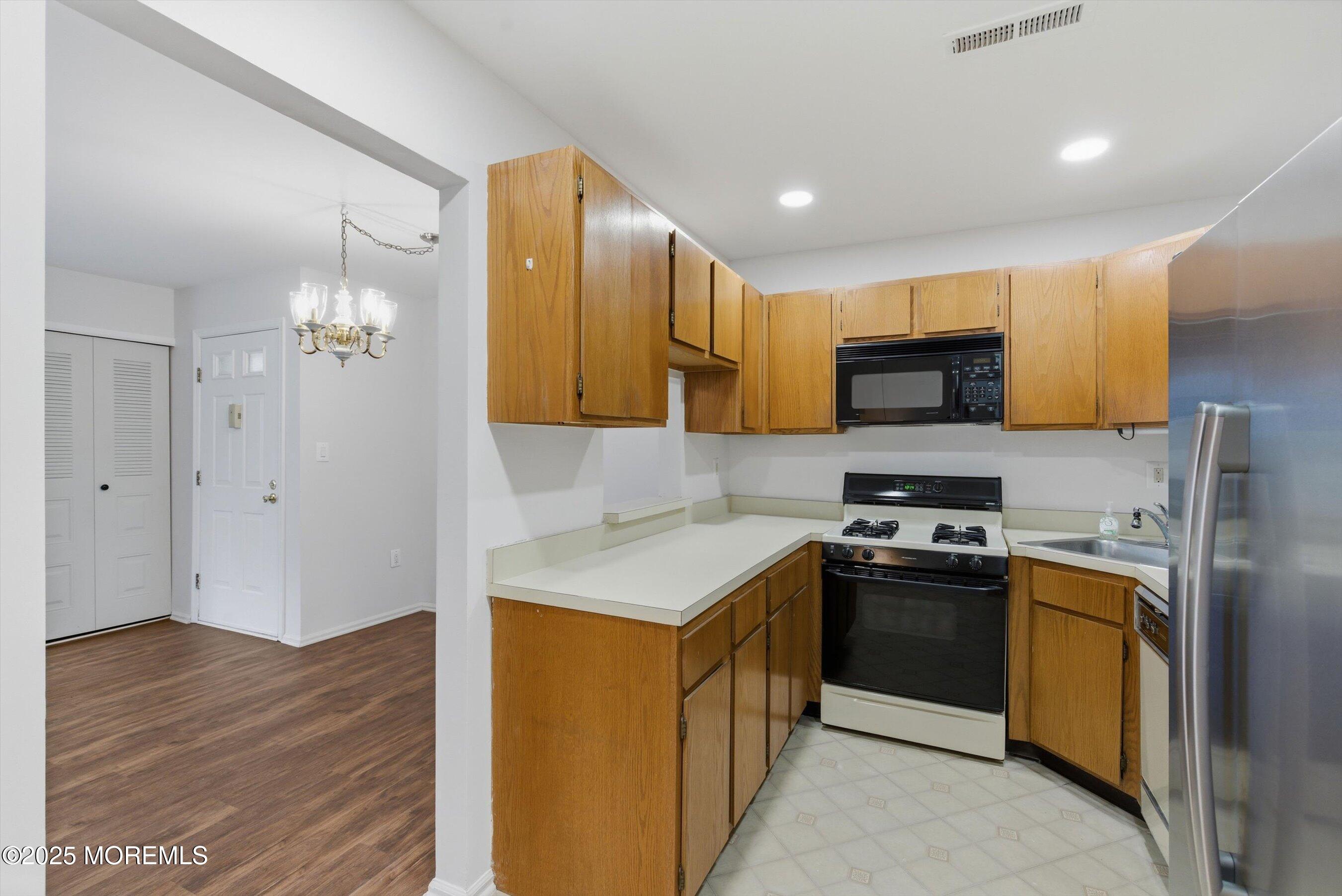 7 Boxwood Terrace, Unit 250 Red Bank, NJ 07701 - Photo 10 of 29 a kitchen with stainless steel appliances granite countertop a sink stove and refrigerator