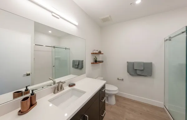 a bathroom with a sink toilet and mirror