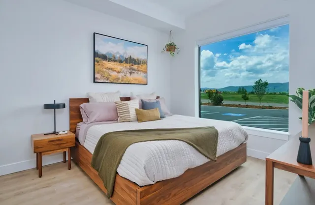 a bedroom with a bed and a painting on the wall