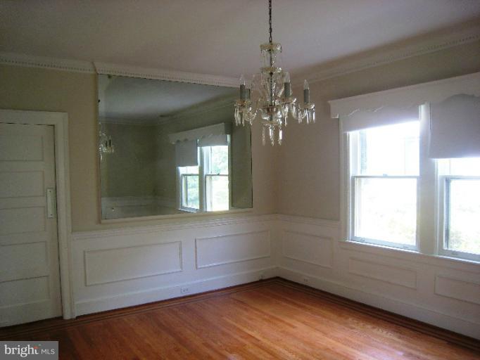 3902 Hadley Square West Baltimore, MD 21218 - Photo 1 of 30 a view of empty room with wooden floor and fan