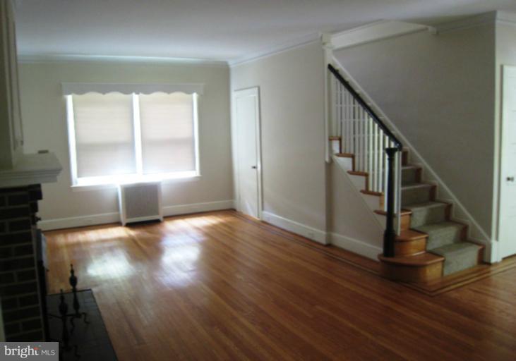 3902 Hadley Square West Baltimore, MD 21218 - Photo 17 of 30 a view of empty room with wooden floor and fan
