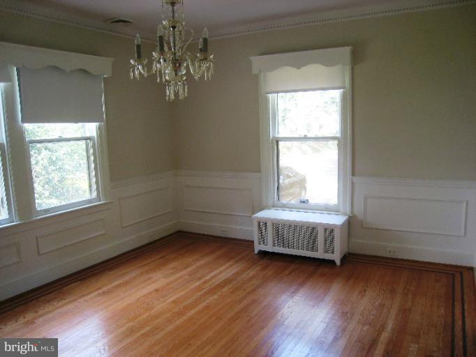 3902 Hadley Square West Baltimore, MD 21218 - Photo 24 of 30 a view of an empty room with wooden floor and a window