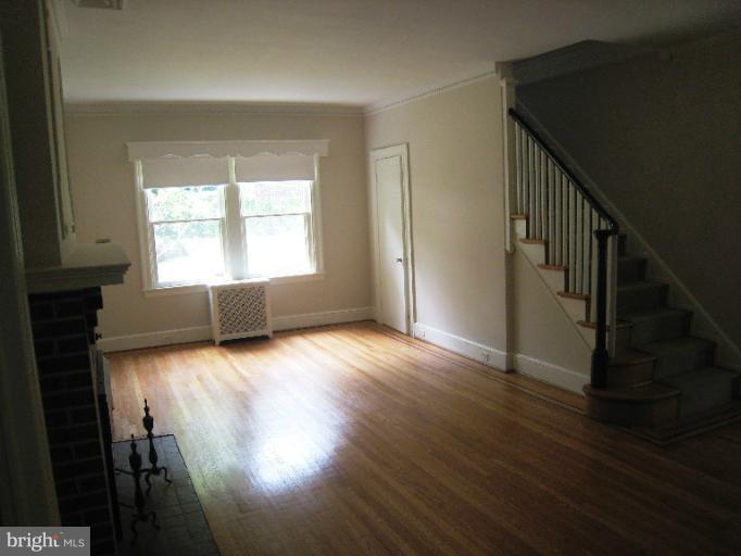 3902 Hadley Square West Baltimore, MD 21218 - Photo 6 of 30 a view of empty room with wooden floor and fan