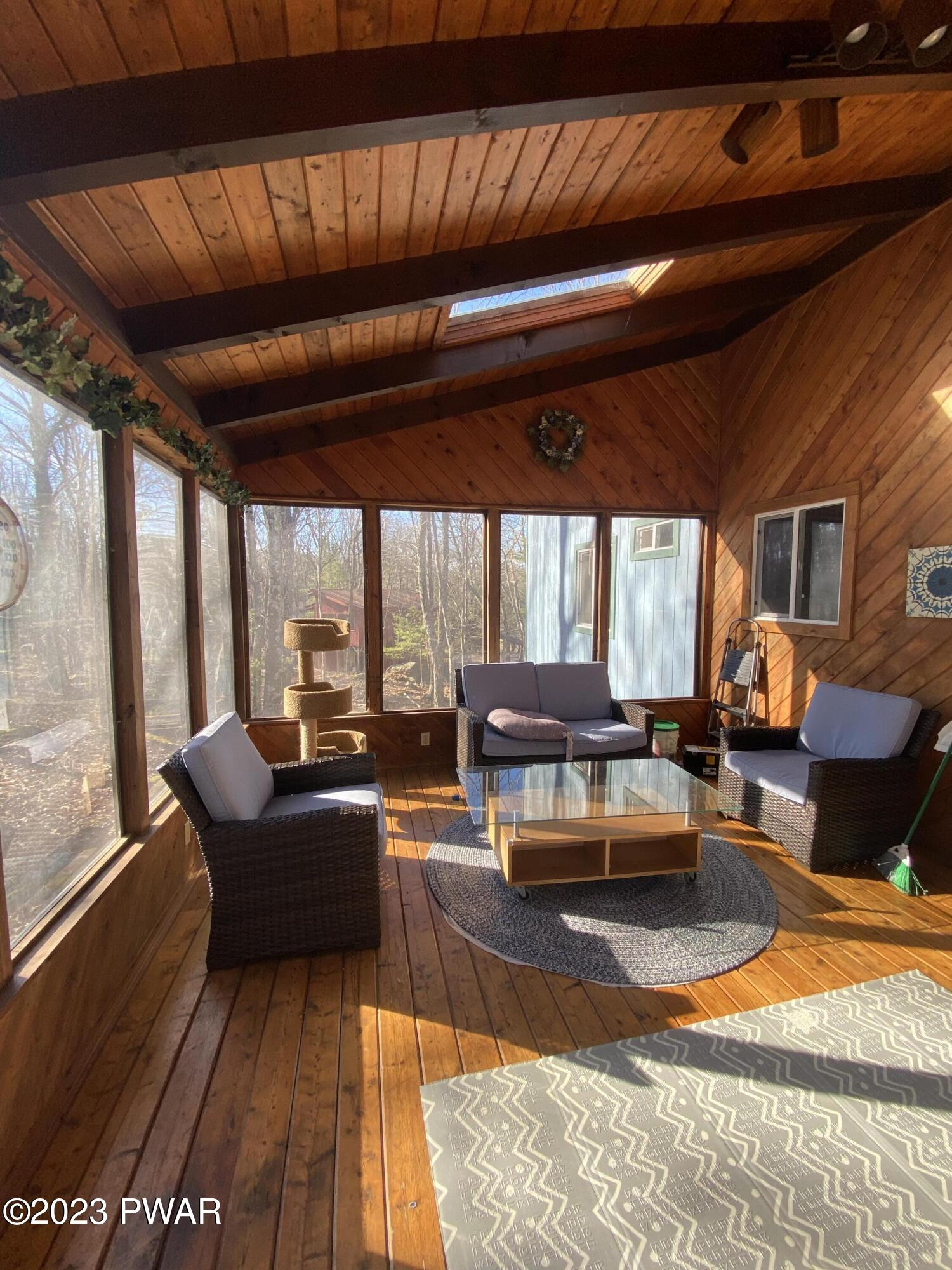101 Maple Ridge Drive Hawley, PA 18428 - Photo 22 of 61 a living room with furniture and a large window