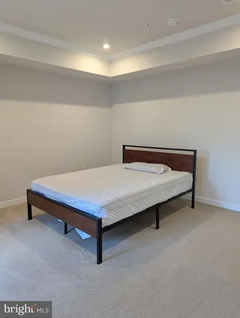 a bedroom with a bed and lamp