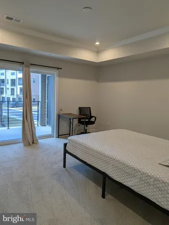 a bed room with a bed and a chair