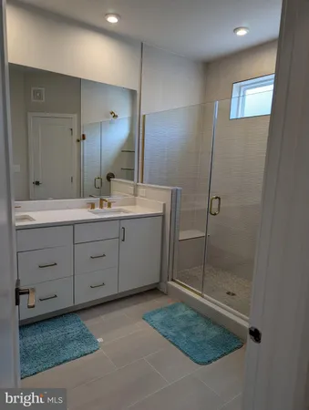 a bathroom with a sink a mirror and a shower