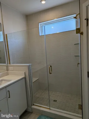 a bathroom with a shower and sink