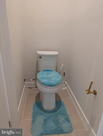 a white toilet sitting in a bathroom