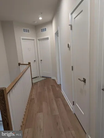 a view of hallway with wooden floor
