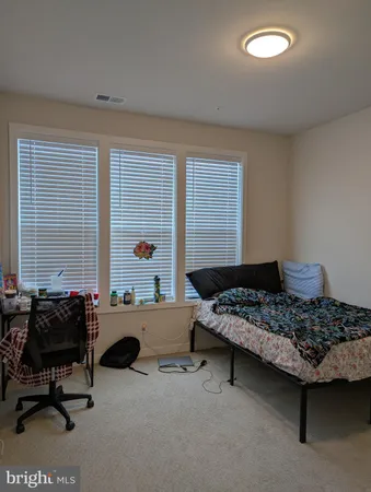 a bedroom with furniture and a window