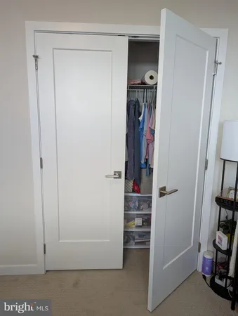 a view of walk in closet with clothes