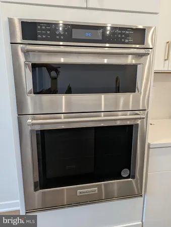 a stove top oven sitting inside of a kitchen