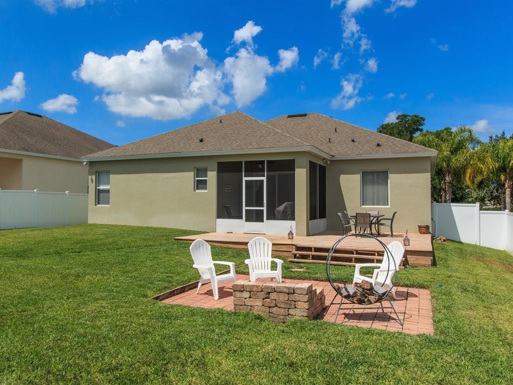 5477 Rishley Run Way Mount Dora, FL 32757 - Photo 22 of 25 a view of a house with backyard sitting area and garden