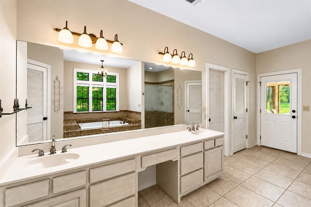 4940 North Frontage Road Winfield, TX 75455 - Photo 29 of 40 Notice the Garden Tub windows have a view of the beautiful outdoor trees! One of the doors leads to the backyard porch.