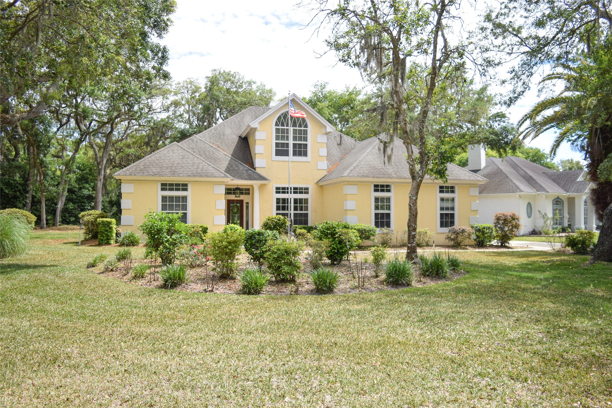 a front view of a house with a garden