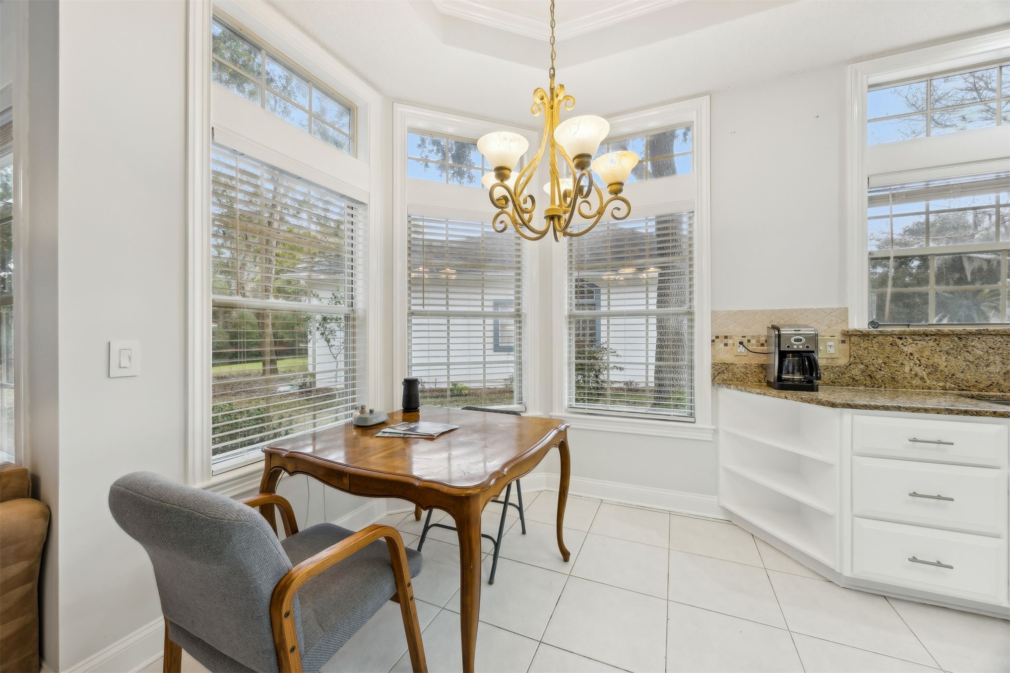 4433 Bean Street Fernandina Beach, FL 32034 - Photo 33 of 79 a dining room with furniture a chandelier and a rug