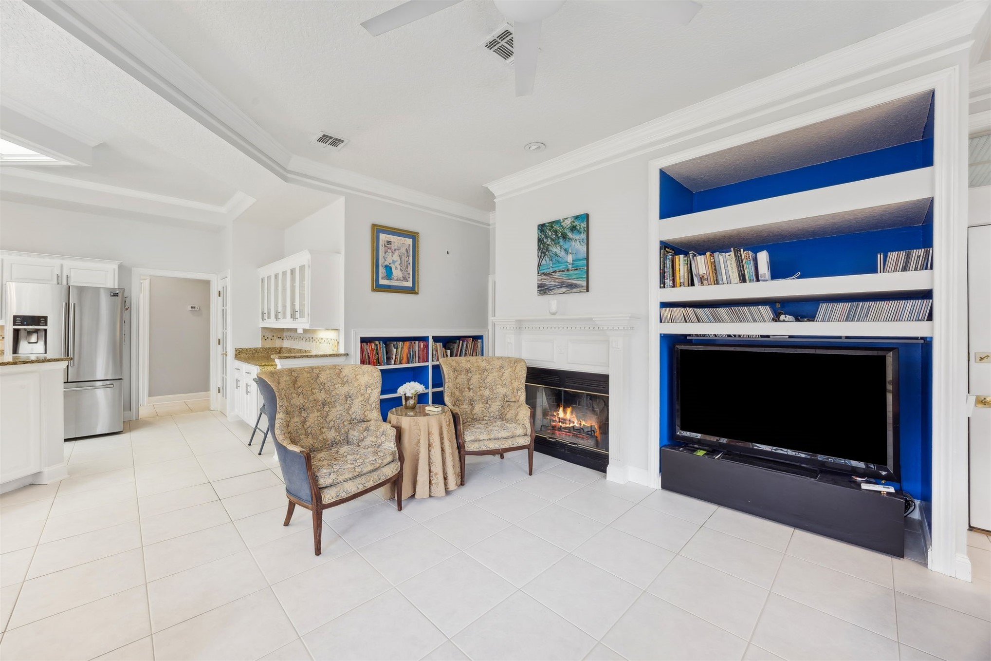 4433 Bean Street Fernandina Beach, FL 32034 - Photo 37 of 79 a living room with furniture a fireplace and a book shelf