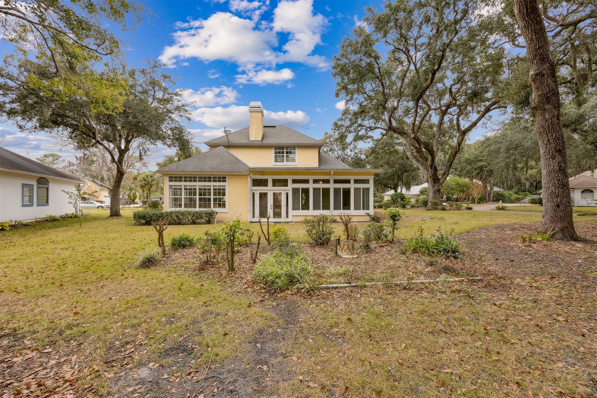 4433 Bean Street Fernandina Beach, FL 32034 - Photo 61 of 79 a front view of a house with a yard tree and outdoor seating