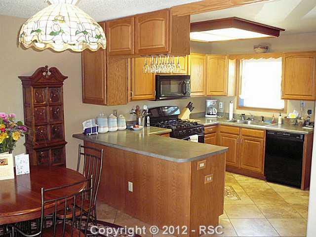 12070 Northcliff Road Elbert, CO 80106 - Photo 10 of 24 Dining room & updated kitchen