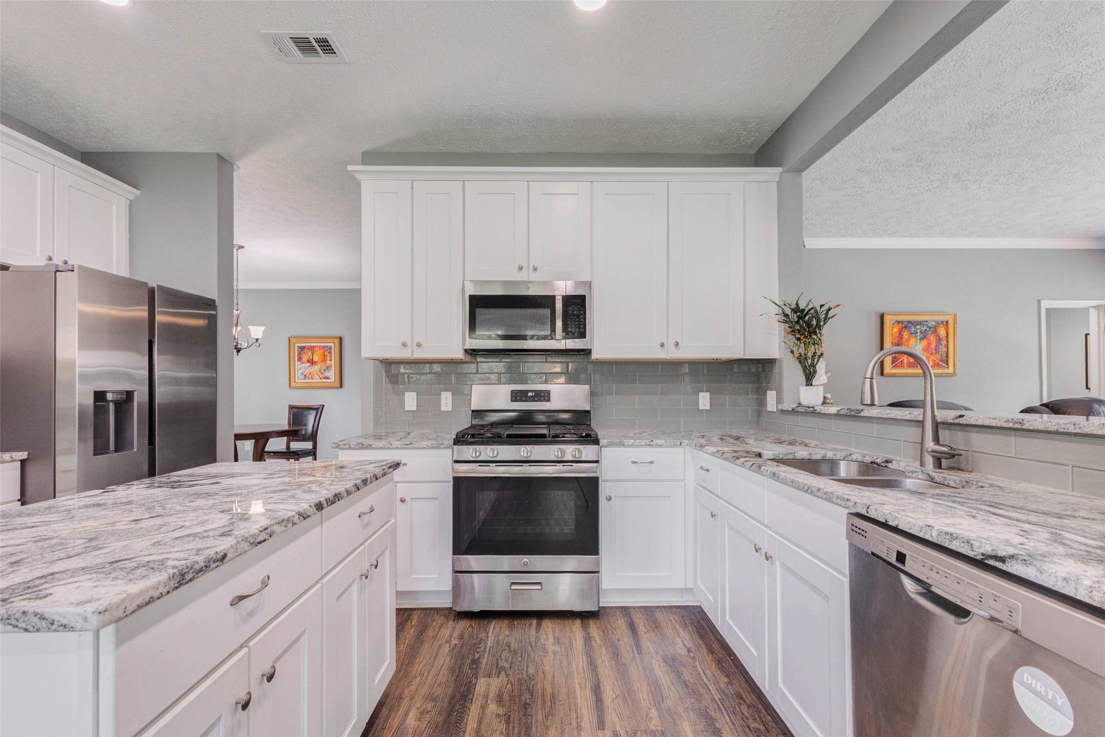 9215 Landry Boulevard Spring, TX 77379 - Photo 12 of 42 The kitchen also features a double basin undermount sink, dishwasher, and an open sightline overlooking the breakfast bar and breakfast area.