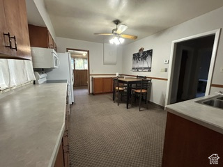 481 East Center Street Logan, UT 84321 - Photo 5 of 23 Kitchen featuring wood-finish cabinetry, light-toned countertops, and carpet flooring