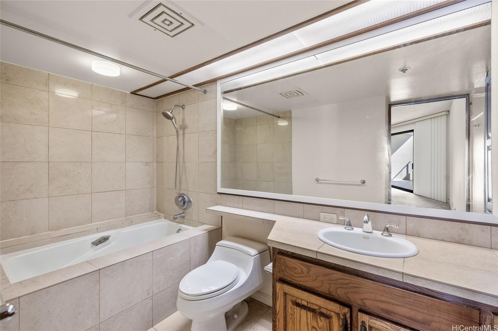 555 Hahaione Street, Unit 3E Honolulu, HI 96825 - Photo 11 of 25 a bathroom with a sink a toilet and shower