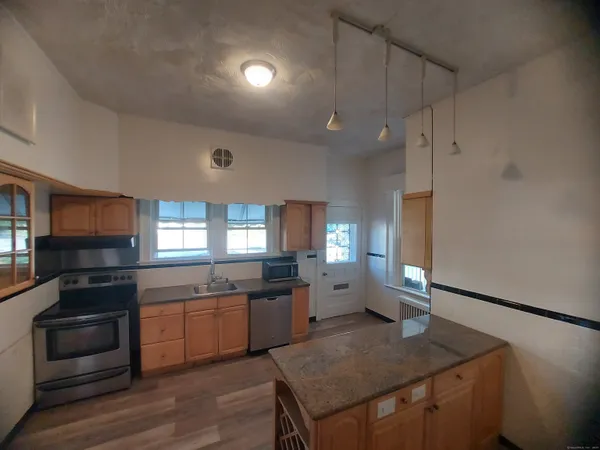a kitchen with a refrigerator cabinet and a sink