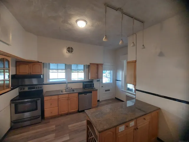 a kitchen with a refrigerator cabinet and a sink