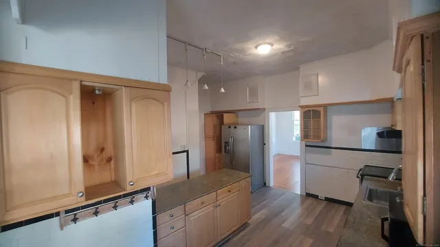 a large kitchen with stainless steel appliances granite countertop a stove and a sink