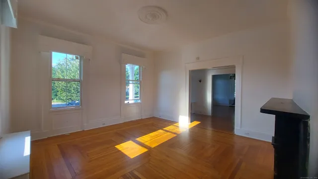 wooden floor in an empty room with a window