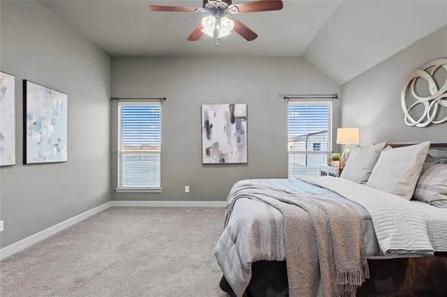 a view of a big yard with a table and a lake view