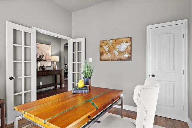 a view of a dining room with furniture a chandelier and wooden floor