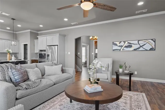 a kitchen with granite countertop a table chairs stove and cabinets