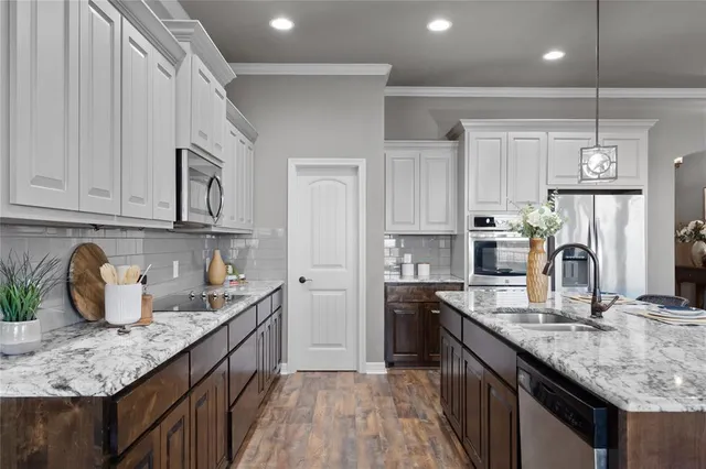 a bedroom with a large bed and a chandelier