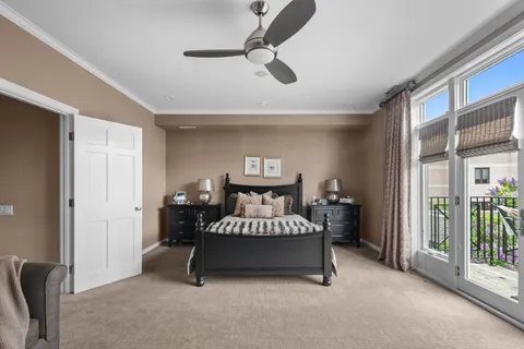 a spacious bedroom with a bed and a chandelier