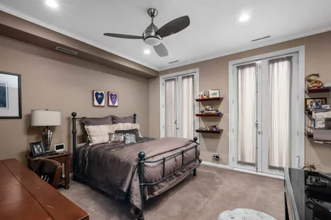 a bedroom with a bed and a chandelier