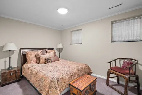 a large bed sitting in a bedroom next to a lamp