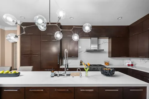 a kitchen with a sink and chandelier