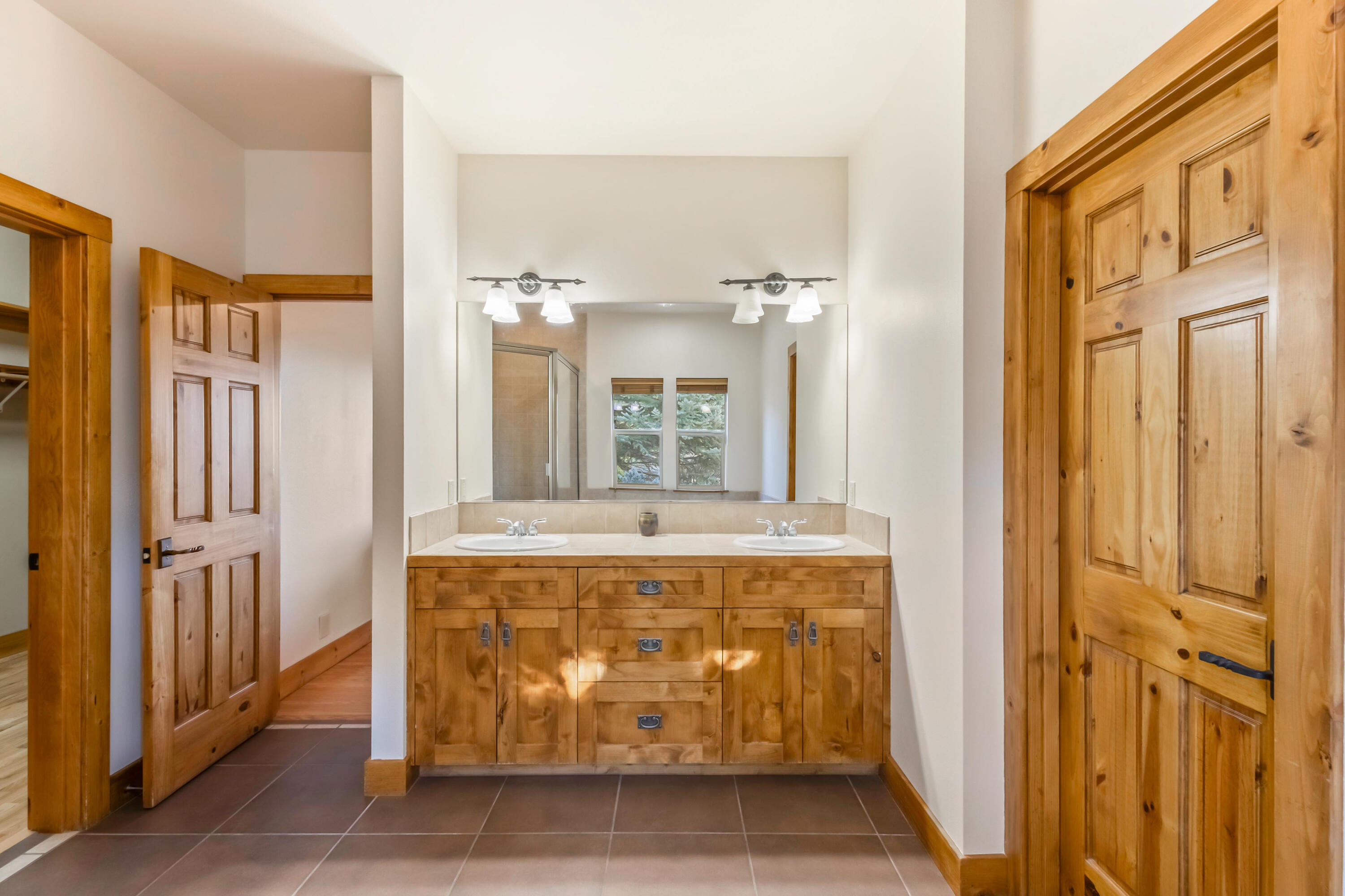 69590 Omaha Road Sisters, OR 97759 - Photo 19 of 46 a spacious bathroom with a granite countertop tub shower and mirror