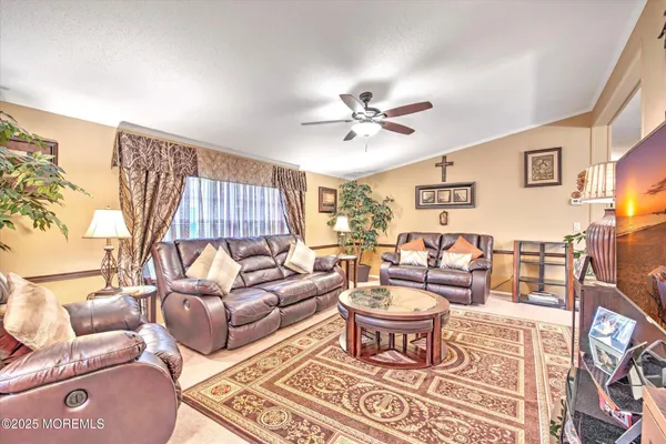 a living room with furniture a rug and a window