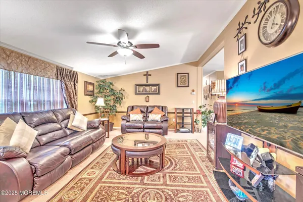 a living room with furniture a rug and a window
