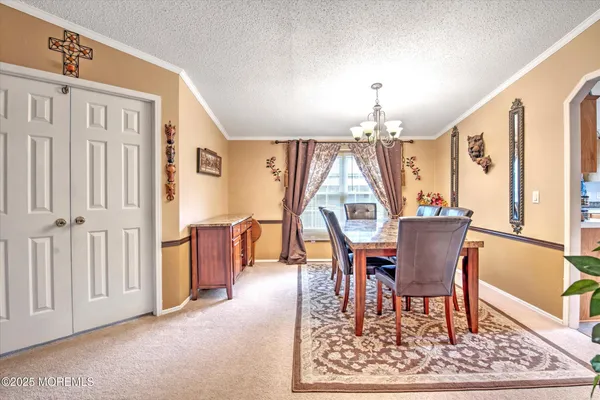 a dining room with furniture window and wooden floor
