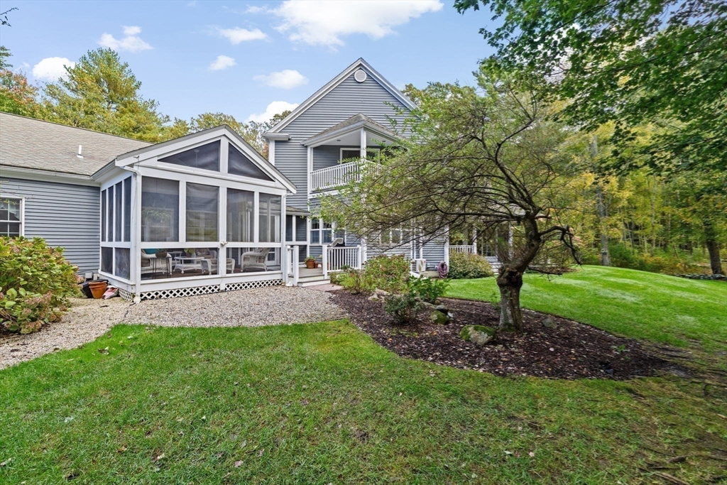 a view of a house with a yard and a garden