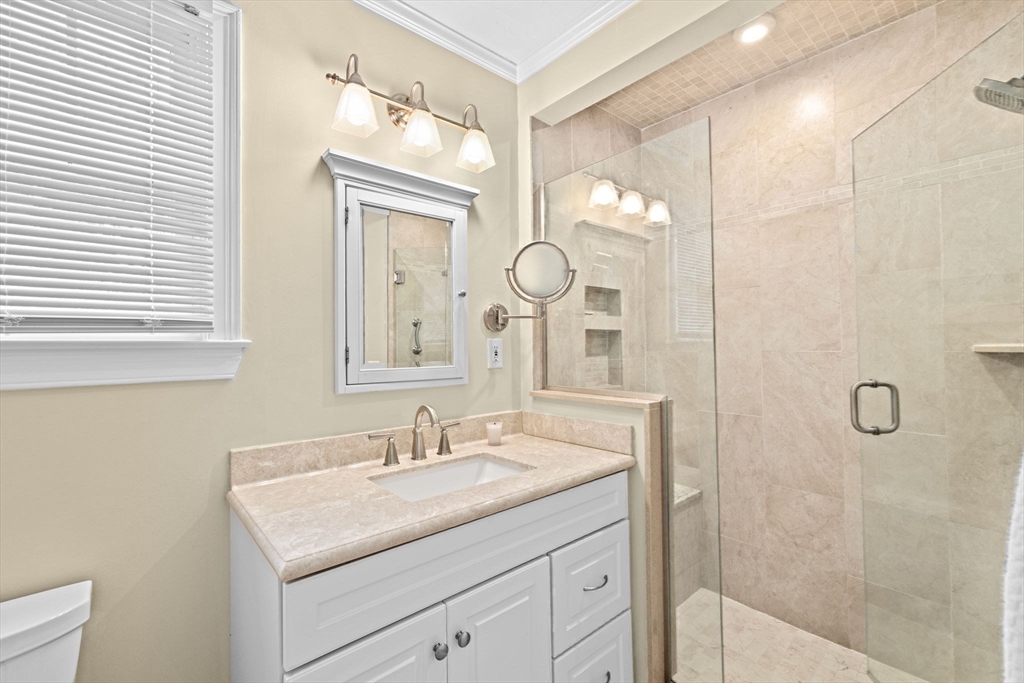 9 Forest Scituate Ma, Unit 9 Scituate, MA 02066 - Photo 25 of 35 a bathroom with a granite countertop sink a mirror and a shower