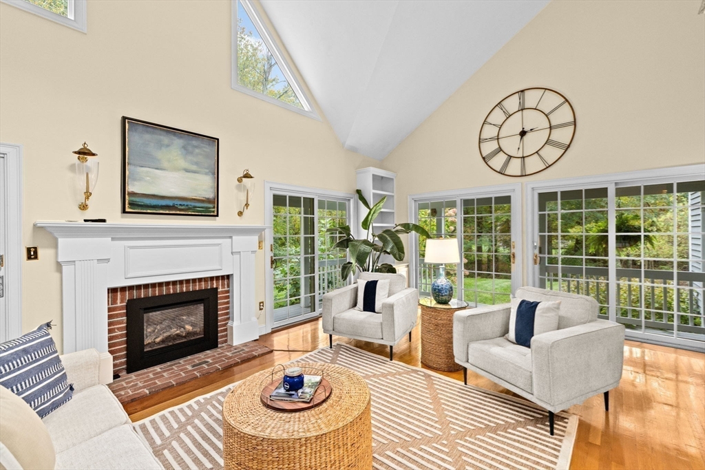 9 Forest Scituate Ma, Unit 9 Scituate, MA 02066 - Photo 6 of 35 a living room with furniture a fireplace and a floor to ceiling window