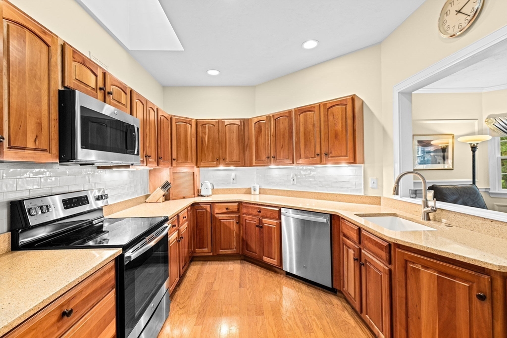 9 Forest Scituate Ma, Unit 9 Scituate, MA 02066 - Photo 7 of 35 a kitchen with stainless steel appliances granite countertop a sink stove microwave and cabinets