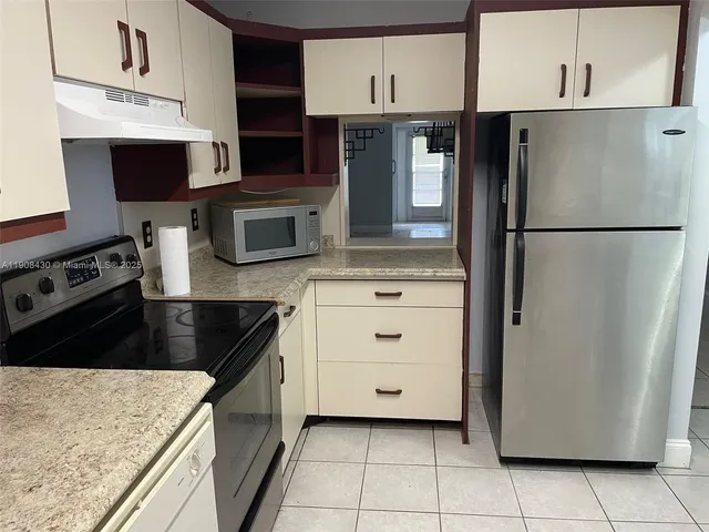 a kitchen with stainless steel appliances a refrigerator stove and microwave
